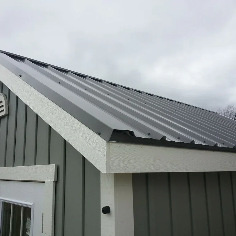 Close up photo of the corner of a garage with a quality metal roof.